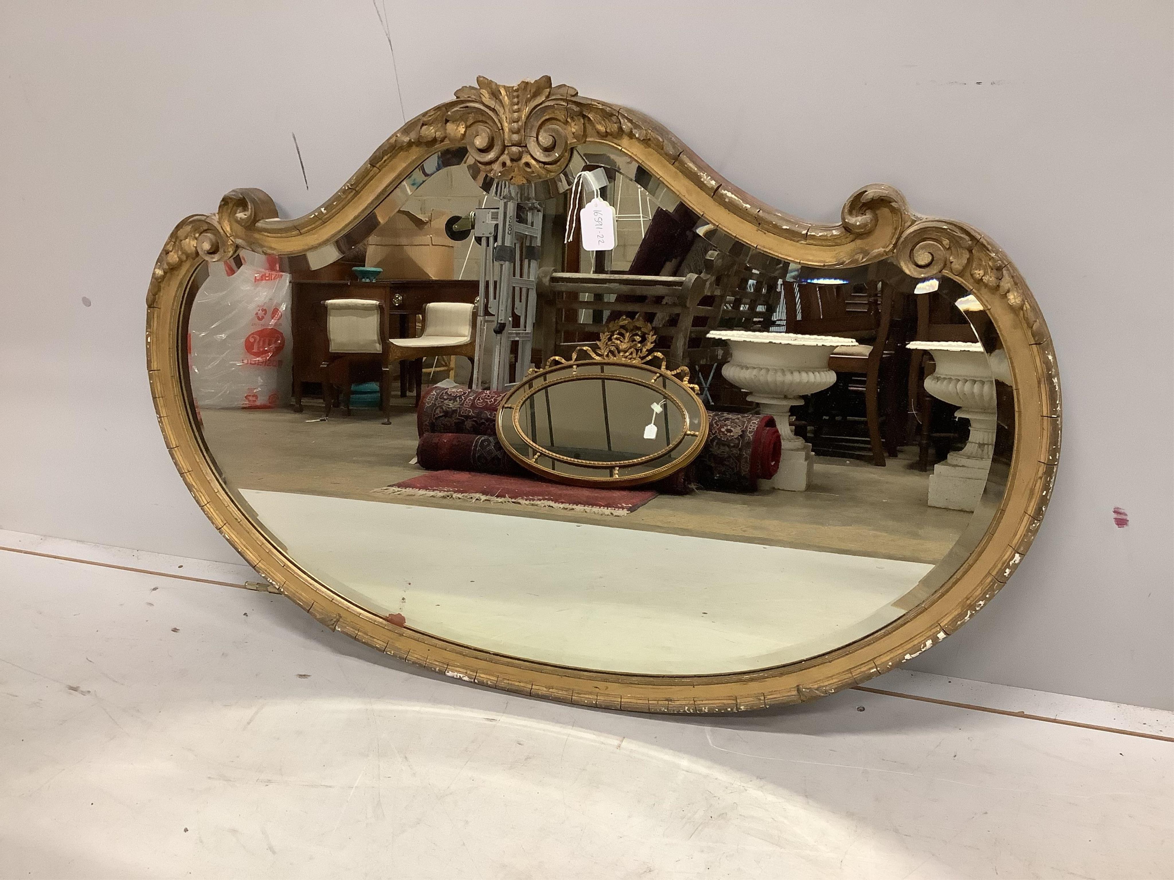 A Victorian giltwood and composition cartouche wall mirror, width 113cm, height 76cm. Condition - poor, losses to pediment and gilding.